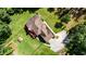 Stunning aerial view of the home and expansive lawn, showcasing the long driveway and wooded surroundings at 6945 John Rivers Rd, Fairburn, GA 30213