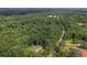 Aerial view showcases the property's mature trees and expansive lawn, creating a peaceful and private retreat at 6945 John Rivers Rd, Fairburn, GA 30213