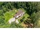 Aerial view of home with landscaped lawn, long driveway, wooded surroundings, and access to a trail at 6945 John Rivers Rd, Fairburn, GA 30213
