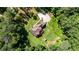 Overhead view of home with backyard patio and lush lawn, set among mature trees and long driveway at 6945 John Rivers Rd, Fairburn, GA 30213