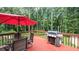 View of the back deck, featuring outdoor dining table, seating, and a grill at 6945 John Rivers Rd, Fairburn, GA 30213