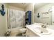 Bathroom with white vanity, tub with shower, and nautical-themed décor at 6945 John Rivers Rd, Fairburn, GA 30213