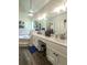 Bathroom with double vanity, wood look floors, and tub at 6945 John Rivers Rd, Fairburn, GA 30213