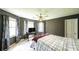 Bedroom featuring a queen bed with neutral-toned walls, a fan, and plenty of natural light at 6945 John Rivers Rd, Fairburn, GA 30213