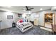 This bedroom has neutral colors and gray patterned floors and a partial view into the work out area at 6945 John Rivers Rd, Fairburn, GA 30213