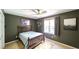Bedroom with neutral decor featuring a bed with a headboard and an area rug at 6945 John Rivers Rd, Fairburn, GA 30213
