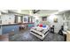 This bedroom has a blue accent wall with three windows and gray patterned floors at 6945 John Rivers Rd, Fairburn, GA 30213