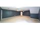 Large bonus room with neutral carpet, ceiling fans, and entry door bathed in ample light at 6945 John Rivers Rd, Fairburn, GA 30213