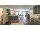 Kitchen flows to dining area with wood floors and large windows bringing in ample light at 6945 John Rivers Rd, Fairburn, GA 30213