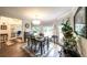 Bright dining room features wood floors, natural light, and modern chandelier at 6945 John Rivers Rd, Fairburn, GA 30213