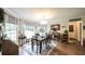 Bright dining room with wood floors, large windows, a modern chandelier, and neutral color palette at 6945 John Rivers Rd, Fairburn, GA 30213