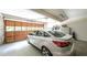 Spacious two-car garage with a white car, storage, and an automated door at 6945 John Rivers Rd, Fairburn, GA 30213