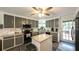 Modern kitchen features ample counter space, grey cabinets, and a central island for cooking at 6945 John Rivers Rd, Fairburn, GA 30213