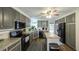 Stylish kitchen with grey cabinets, granite countertops, and stainless steel appliances at 6945 John Rivers Rd, Fairburn, GA 30213