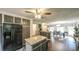 Open kitchen with stainless steel appliances, a granite island, and an eat-in dining area at 6945 John Rivers Rd, Fairburn, GA 30213