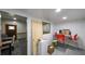 This room has a table with chairs, a door with leaded glass, and gray patterned floors at 6945 John Rivers Rd, Fairburn, GA 30213