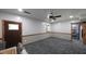 This living room has gray patterned floors, a ceiling fan, and a door with leaded glass at 6945 John Rivers Rd, Fairburn, GA 30213
