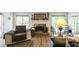 Inviting living room featuring a fireplace, hardwood floors, and plenty of natural light at 6945 John Rivers Rd, Fairburn, GA 30213