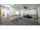 Open living space with gray carpeting, neutral walls, and rustic trim, creating a cozy and inviting atmosphere at 6945 John Rivers Rd, Fairburn, GA 30213