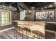 Rustic basement bar area with wooden counter, stools, and wine-themed decor at 910 Kings Arms Way, Johns Creek, GA 30022
