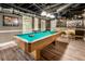Basement game room featuring a pool table and custom-built bar for entertainment at 910 Kings Arms Way, Johns Creek, GA 30022