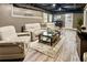Finished basement featuring a seating area, plank flooring, with an exposed ceiling and neutral paint at 910 Kings Arms Way, Johns Creek, GA 30022