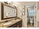Bathroom featuring double vanity, granite countertops, a large mirror and decor with a toilet room at 910 Kings Arms Way, Johns Creek, GA 30022