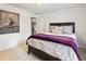 Bedroom featuring neutral carpet, a painting, and window for natural light at 910 Kings Arms Way, Johns Creek, GA 30022
