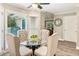 Cozy breakfast nook with tufted chairs, hardwood floors, and a glass table for casual dining at 910 Kings Arms Way, Johns Creek, GA 30022
