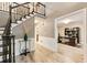 Inviting foyer with staircase, detailed trim, and hardwood floors, open to a bright home office at 910 Kings Arms Way, Johns Creek, GA 30022