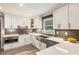 Bright kitchen featuring white cabinets, quartz countertops, modern appliances, and a stainless steel sink at 910 Kings Arms Way, Johns Creek, GA 30022