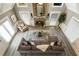 Aerial view of living room showcasing a stone fireplace, large windows, and comfortable seating at 910 Kings Arms Way, Johns Creek, GA 30022