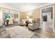 Comfortable living room with neutral tones, with an open view to the dining room and office at 910 Kings Arms Way, Johns Creek, GA 30022