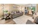 Inviting living room with modern lighting fixtures and an open floor plan leading to the dining area at 910 Kings Arms Way, Johns Creek, GA 30022