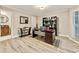 Bright home office with built-in shelving, natural light, and views of the landscaped exterior at 910 Kings Arms Way, Johns Creek, GA 30022