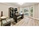 Well-lit home office features modern desk, stylish decor, and large windows for a great workspace at 910 Kings Arms Way, Johns Creek, GA 30022
