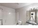 Bathroom with shower-tub, white toilet, large mirror, and a three light vanity fixture at 1001 Balsam Wood Trl, Villa Rica, GA 30180