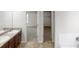 Bathroom with a double sink vanity, tile floors and access to an adjacent bedroom and closet at 1001 Balsam Wood Trl, Villa Rica, GA 30180