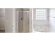 Bright bathroom featuring a walk-in shower and a soaking tub under a window with tiled backsplash at 1001 Balsam Wood Trl, Villa Rica, GA 30180