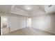 Bright bedroom highlighting tray ceiling, and door to bathroom at 1001 Balsam Wood Trl, Villa Rica, GA 30180