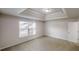 Bedroom featuring a tray ceiling, large window, and carpet at 1001 Balsam Wood Trl, Villa Rica, GA 30180