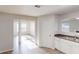 Open-concept kitchen area with stainless sink, neutral walls, and modern wood-look floors at 1001 Balsam Wood Trl, Villa Rica, GA 30180