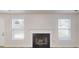 Living room showcases fireplace flanked by windows at 1001 Balsam Wood Trl, Villa Rica, GA 30180