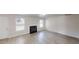 Comfortable living room featuring a fireplace, modern floors, and a bright, airy feel at 1001 Balsam Wood Trl, Villa Rica, GA 30180