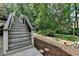 Backyard stairs leading to landscaped garden area with stone decorations at 1019 Wolf Springs Ct, Lawrenceville, GA 30043