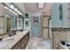 Bathroom with double granite vanity and a separate tiled shower with a glass door at 1019 Wolf Springs Ct, Lawrenceville, GA 30043