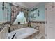 Bathroom featuring a white soaking tub with a window view and granite trim at 1019 Wolf Springs Ct, Lawrenceville, GA 30043