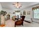Comfortable bedroom with ceiling fan, sitting area, and abundant natural light at 1019 Wolf Springs Ct, Lawrenceville, GA 30043