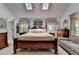 Bedroom with a four-poster bed, natural light, and an ensuite at 1019 Wolf Springs Ct, Lawrenceville, GA 30043