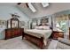 Cozy bedroom featuring a four-poster bed, vaulted ceiling, and traditional furnishings at 1019 Wolf Springs Ct, Lawrenceville, GA 30043